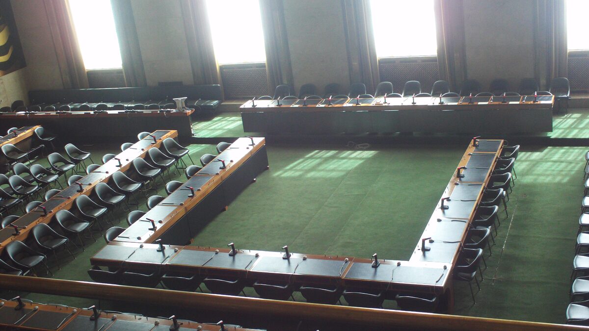 Delegates' tables arranged in the Council Chamber of the Palace of Nations in Geneva.